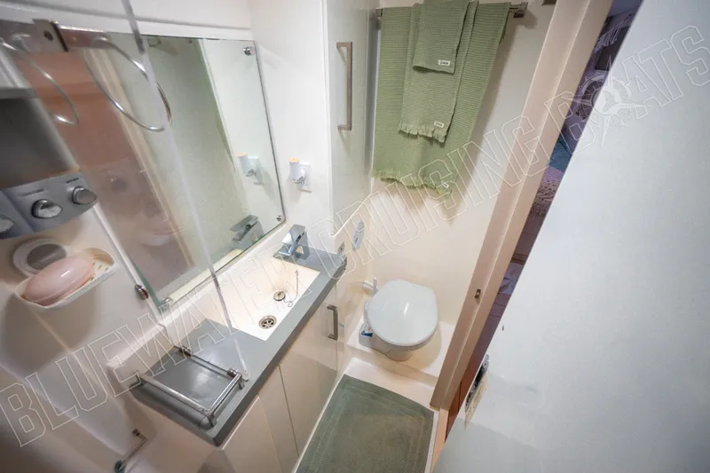 Sea Dog Yacht Photos Pics Modern bathroom in 2020 Leopard 58 yacht with sink, toilet, and green towels.