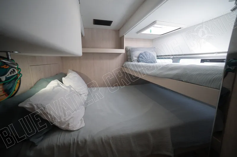 Sea Dog Yacht Photos Pics Cozy cabin interior of 2020 Leopard 58 yacht with bunk beds and soft lighting.