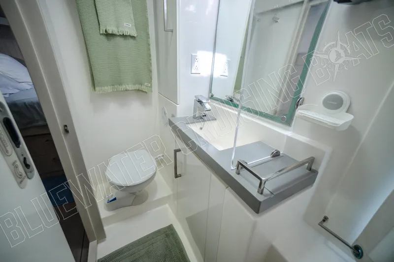 Sea Dog Yacht Photos Pics Modern bathroom in 2020 Leopard 58 yacht with sleek fixtures and green accents.