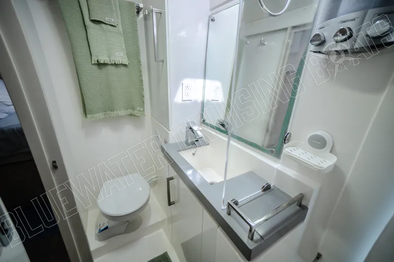 Sea Dog Yacht Photos Pics Modern bathroom in 2020 Leopard 58 yacht with sleek fixtures and green towels.