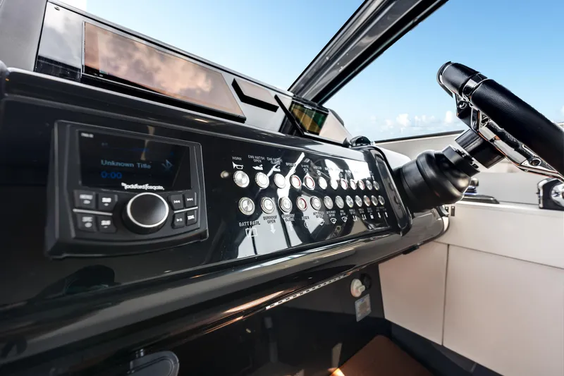  Yacht Photos Pics Control panel of 2023 Cruisers Yachts 42 GLS OB with steering wheel and audio system.
