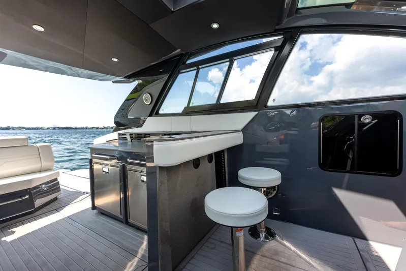  Yacht Photos Pics 2023 Cruisers Yachts 42 GLS OB interior with bar stools and sleek design.