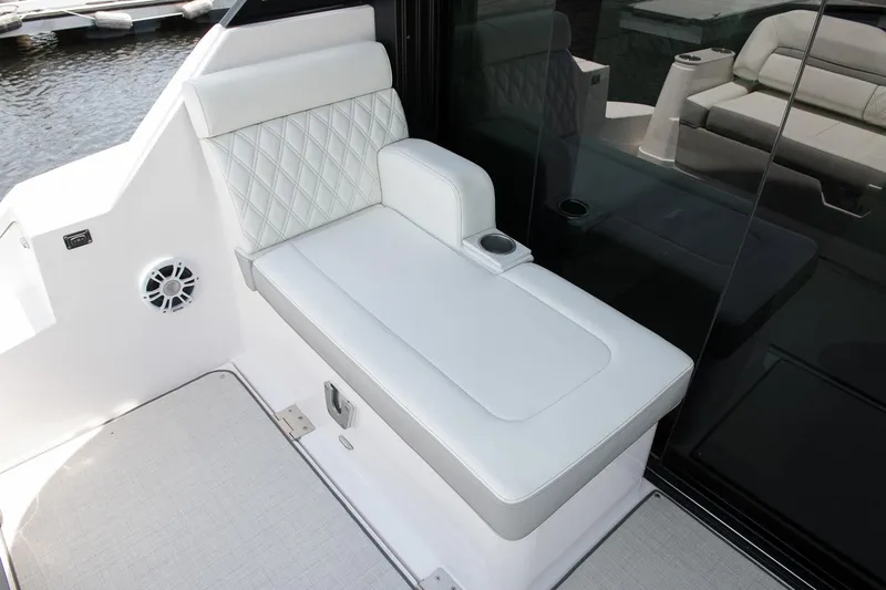  Yacht Photos Pics Manufacturer Provided Image: 2026 Regal 36 Grande Coupe boat interior with white cushioned seating and cup holder.