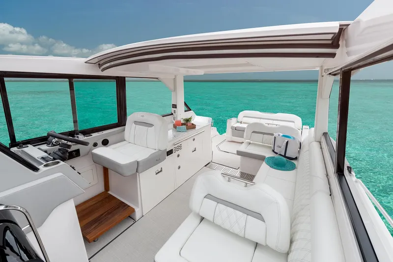  Yacht Photos Pics Manufacturer Provided Image: 2026 Regal 36 Grande Coupe interior with luxurious seating, overlooking turquoise ocean waters.