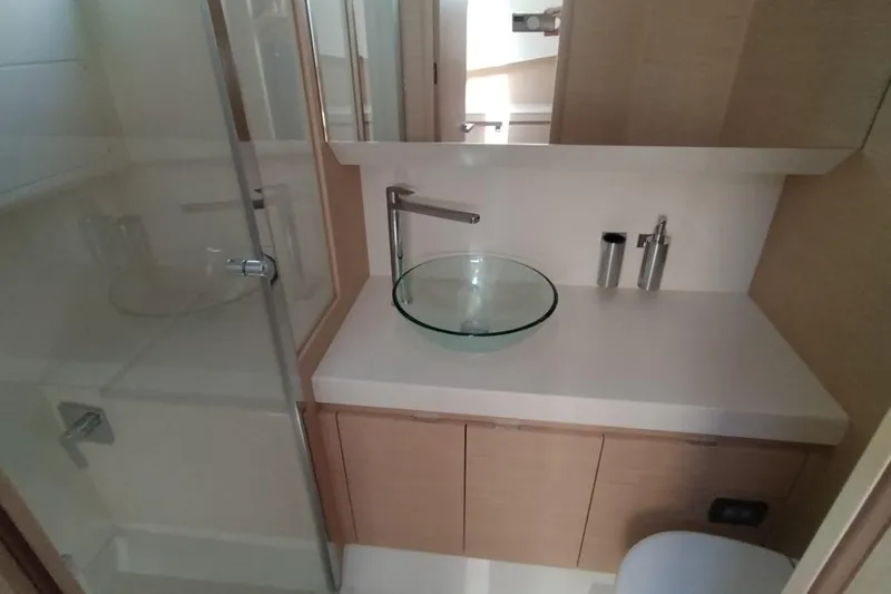  Yacht Photos Pics Modern bathroom in 2025 Solaris Power 44 Open yacht, featuring glass sink and sleek fixtures.