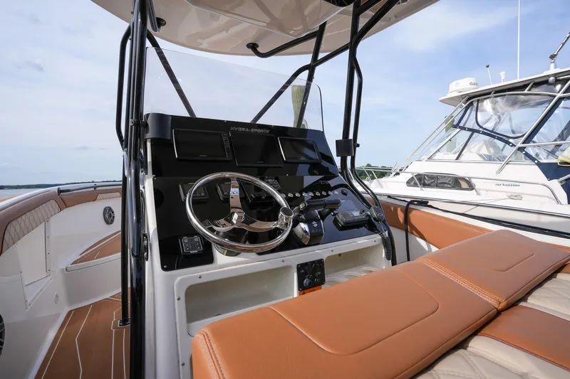  Yacht Photos Pics 2000 Hydra-Sports 2796 Vector boat cockpit with steering wheel and tan seating.