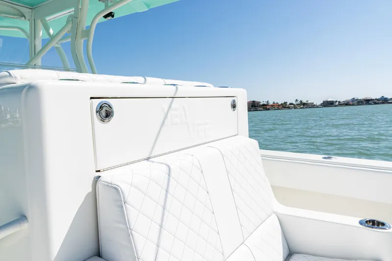  Yacht Photos Pics 2015 SeaVee 390Z boat interior with white cushioned seating, ocean view in background.