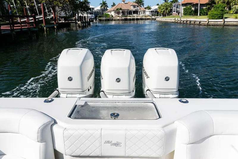  Yacht Photos Pics 2015 SeaVee 390Z boat with triple outboard engines on a calm waterway.