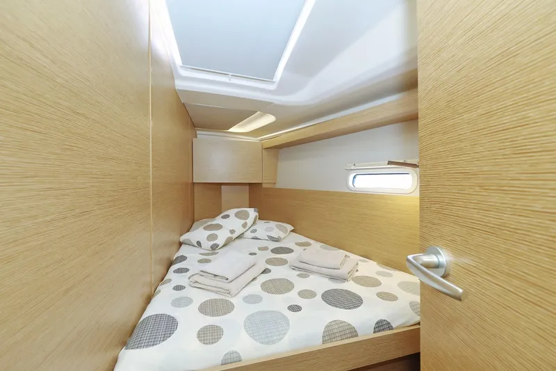 Apollo Yacht Photos Pics Cozy cabin interior of 2019 Hanse 458 yacht with polka dot bedding.