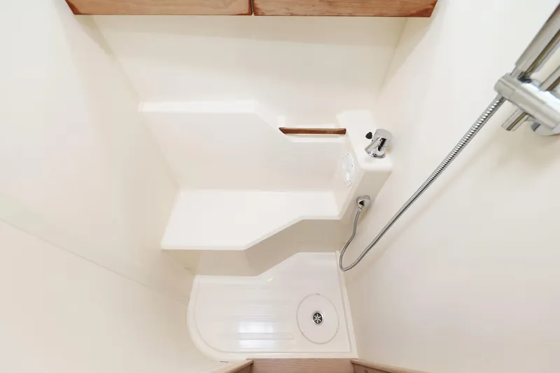 Apollo Yacht Photos Pics Compact shower area in 2019 Hanse 458 yacht, featuring modern fixtures and white interior.