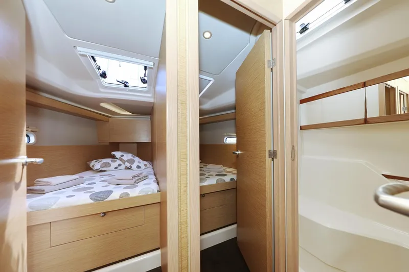 Apollo Yacht Photos Pics Interior of 2019 Hanse 458 yacht showing cozy twin cabins with wooden finish.