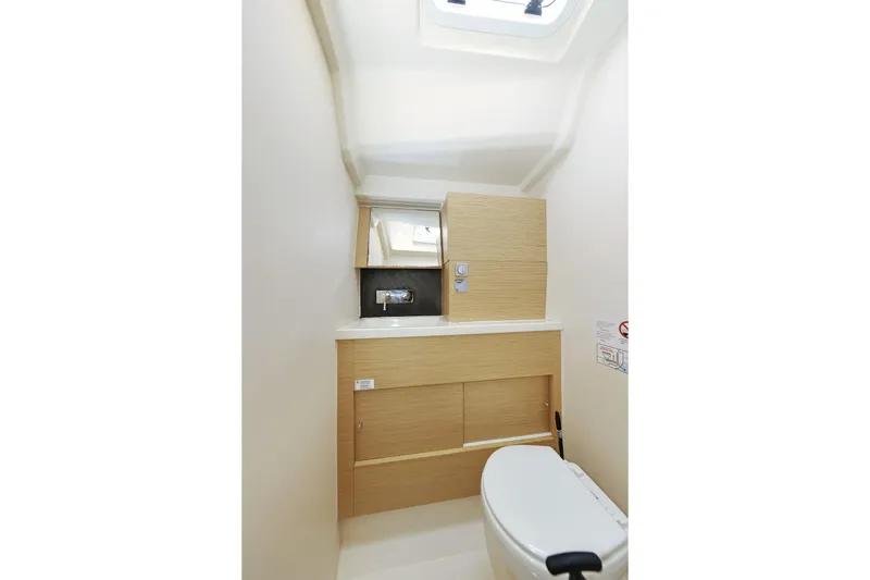 Apollo Yacht Photos Pics Compact bathroom in 2019 Hanse 458 yacht with modern fixtures and light wood cabinetry.