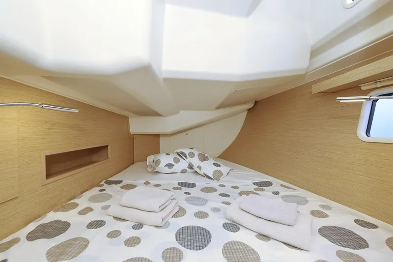 Apollo Yacht Photos Pics Cozy cabin interior of 2019 Hanse 458 yacht with polka dot bedding and towels.