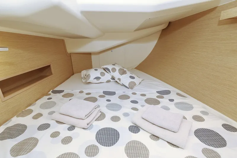 Apollo Yacht Photos Pics Cozy cabin interior of 2019 Hanse 458 yacht with polka dot bedding and towels.