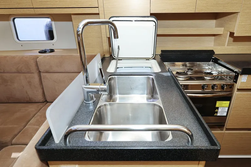 Apollo Yacht Photos Pics Modern kitchen interior of 2019 Hanse 458 yacht with stainless steel sink and stove.