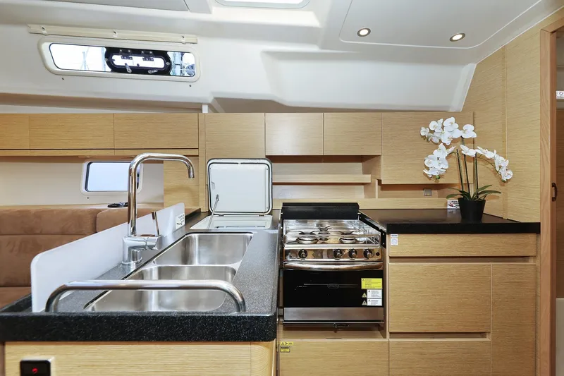Apollo Yacht Photos Pics Modern kitchen interior of 2019 Hanse 458 yacht with sleek design and stainless steel appliances.