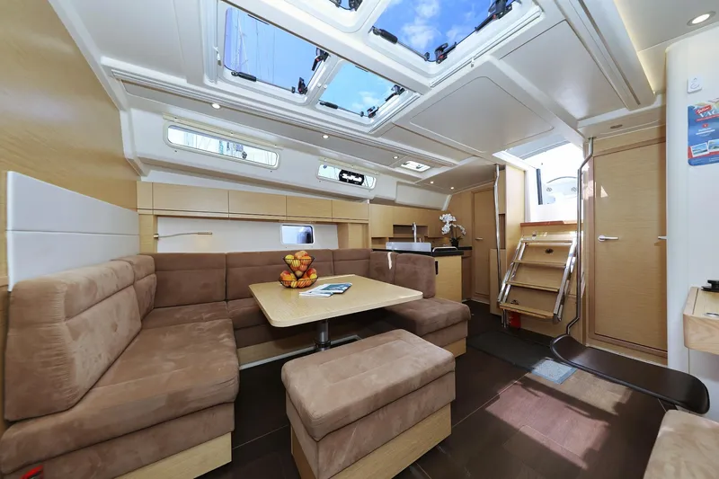 Apollo Yacht Photos Pics Luxurious interior of 2019 Hanse 458 yacht with skylights and cozy seating area.