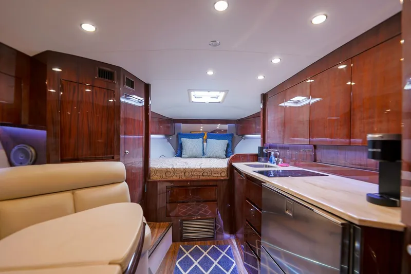 Tranquila Yacht Photos Pics Luxurious interior of 2016 Jupiter 41 EX yacht with wood finishes and modern amenities.