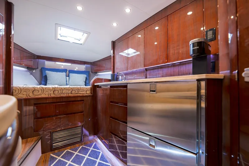 Tranquila Yacht Photos Pics Luxurious interior of 2016 Jupiter 41 EX yacht with modern kitchen and cozy sleeping area.