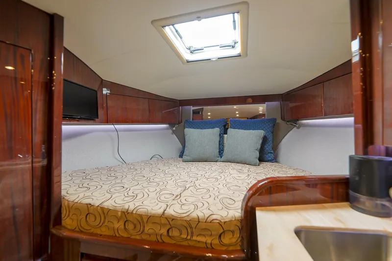 Tranquila Yacht Photos Pics Luxurious cabin interior of 2016 Jupiter 41 EX yacht with cozy bed and modern amenities.