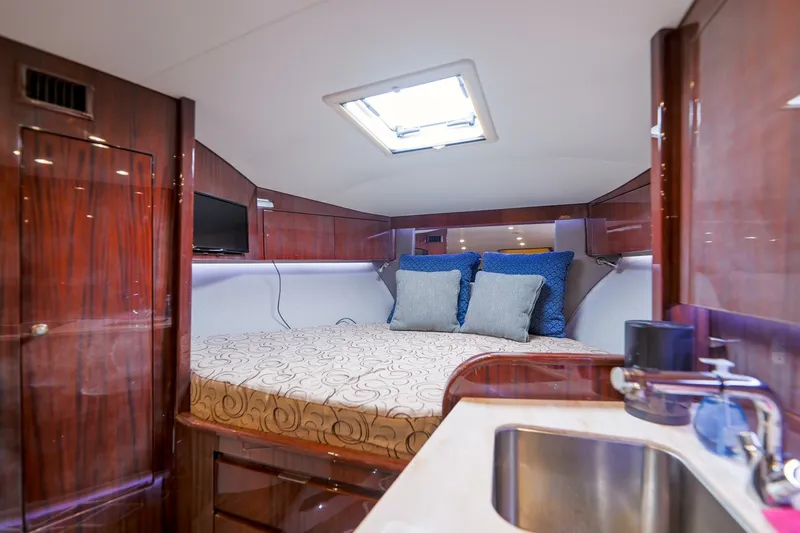 Tranquila Yacht Photos Pics Luxurious cabin interior of 2016 Jupiter 41 EX yacht with bed and sink.