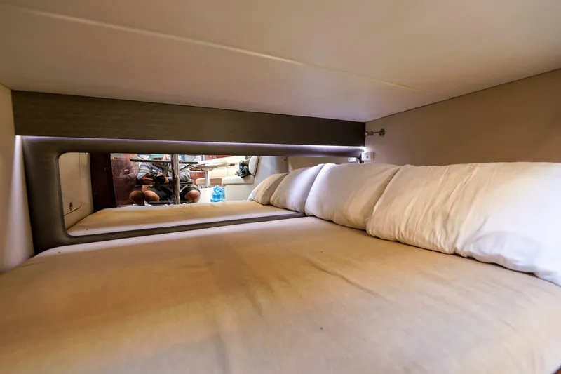 Tranquila Yacht Photos Pics Cozy cabin bed in 2016 Jupiter 41 EX boat, featuring plush pillows and modern design.