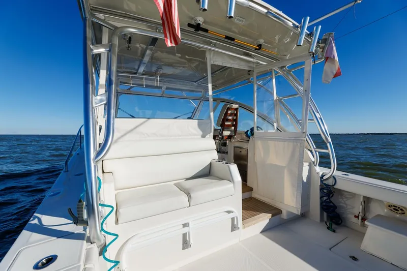 Tranquila Yacht Photos Pics 2016 Jupiter 41 EX boat interior with seating, ocean view, and clear blue sky.