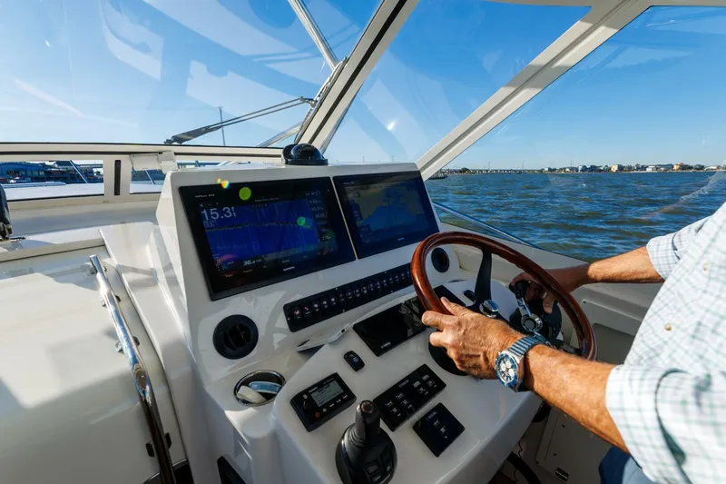 Tranquila Yacht Photos Pics Helm of 2016 Jupiter 41 EX boat with dual screens and steering wheel.