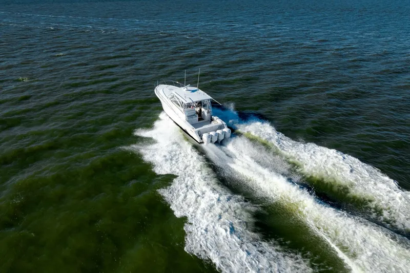 Tranquila Yacht Photos Pics 2016 Jupiter 41 EX boat cruising on open water, creating a wake.