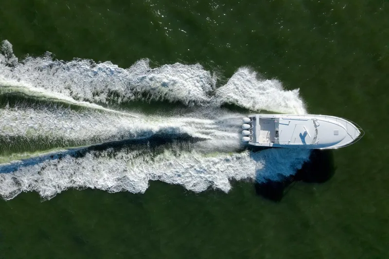 Tranquila Yacht Photos Pics Aerial view of 2016 Jupiter 41 EX boat speeding on water.