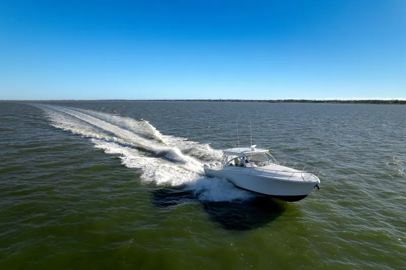 Tranquila Yacht Photos Pics Jupiter 41 EX 2016 boat cruising on open water under clear blue sky.