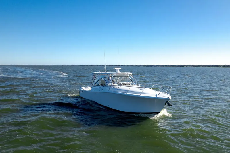Tranquila Yacht Photos Pics 2016 Jupiter 41 EX boat cruising on open water under clear blue sky.