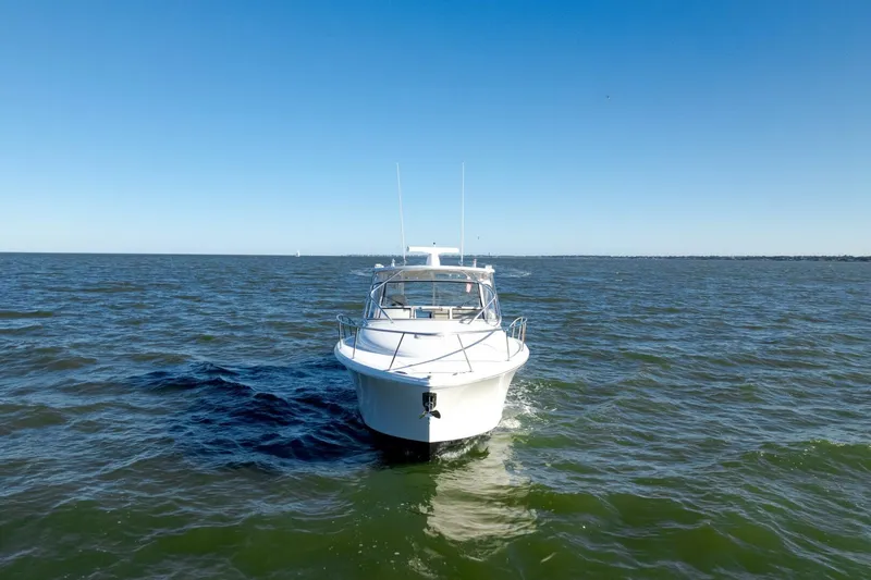 Tranquila Yacht Photos Pics 2016 Jupiter 41 EX boat cruising on open water under clear blue sky.