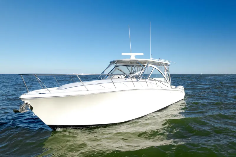 Tranquila Yacht Photos Pics 2016 Jupiter 41 EX boat cruising on open water under clear blue sky.