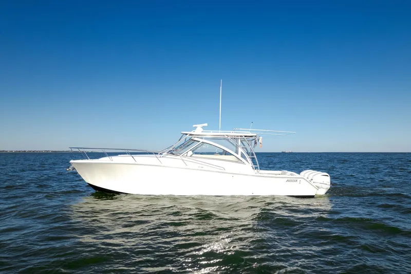 Tranquila Yacht Photos Pics 2016 Jupiter 41 EX boat on open water under clear blue sky.