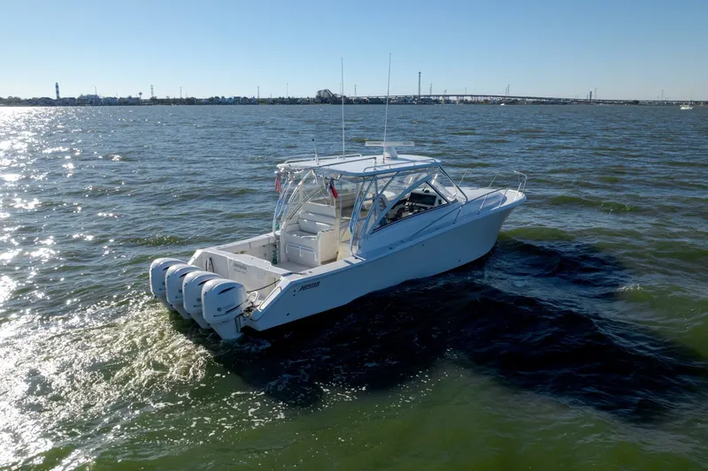 Tranquila Yacht Photos Pics 2016 Jupiter 41 EX boat cruising on open water, featuring triple outboard engines.