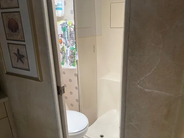 Lady G Yacht Photos Pics 1998 Ocean Yachts 45 Super Sport bathroom with shower and framed marine art.