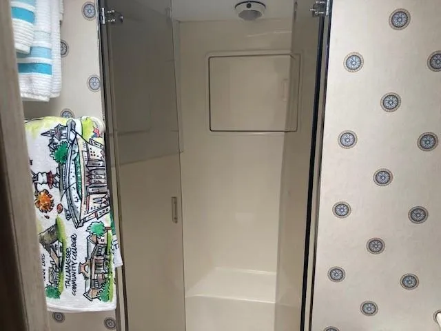 Lady G Yacht Photos Pics Shower area in 1998 Ocean Yachts 45 Super Sport with patterned wallpaper and colorful towel.