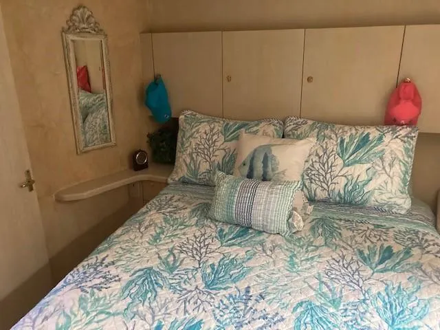 Lady G Yacht Photos Pics 1998 Ocean Yachts 45 Super Sport bedroom with coastal-themed bedding.