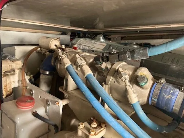 Lady G Yacht Photos Pics Engine compartment of a 1998 Ocean Yachts 45 Super Sport with blue hoses and mechanical components.