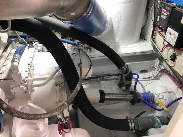  Yacht Photos Pics Engine room of a 1997 Bertram Convertible boat with hoses and mechanical components.