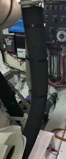  Yacht Photos Pics Engine room of a 1997 Bertram Convertible boat with visible wiring and hoses.