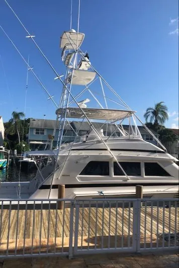  Yacht Photos Pics 1997 Bertram Convertible yacht docked at a marina on a sunny day.
