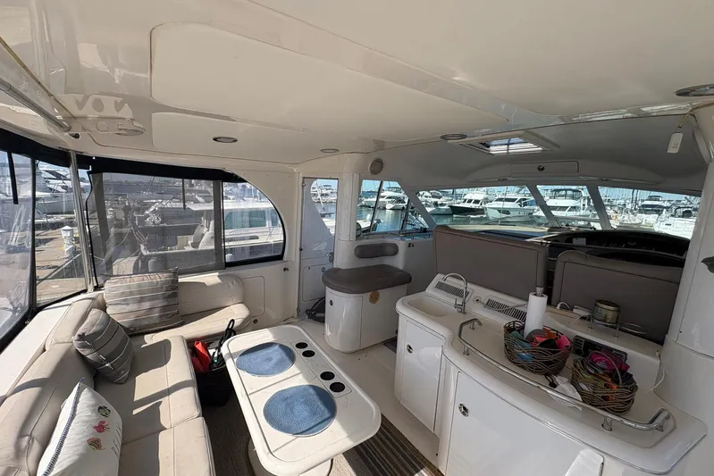 Andiamo II Yacht Photos Pics Interior of 2002 Sea Ray 480 Motor Yacht with seating and kitchenette, docked at marina.