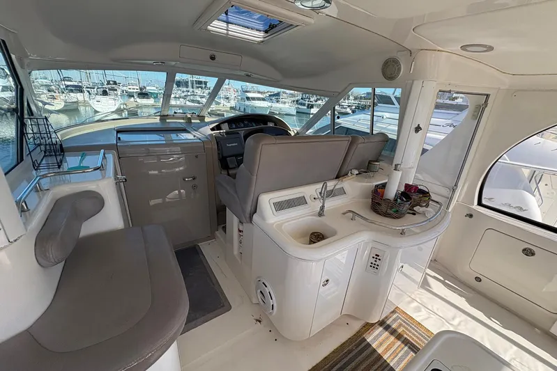 Andiamo II Yacht Photos Pics Interior of 2002 Sea Ray 480 Motor Yacht with helm, seating, and kitchenette.