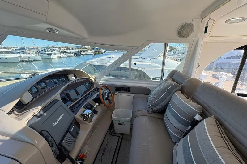 Andiamo II Yacht Photos Pics 2002 Sea Ray 480 Motor Yacht helm with plush seating and marina view.