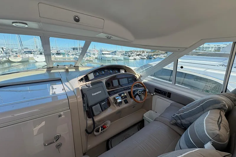 Andiamo II Yacht Photos Pics Interior view of 2002 Sea Ray 480 Motor Yacht helm with marina backdrop.
