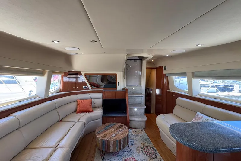 Andiamo II Yacht Photos Pics Luxurious interior of 2002 Sea Ray 480 Motor Yacht with plush seating and elegant decor.