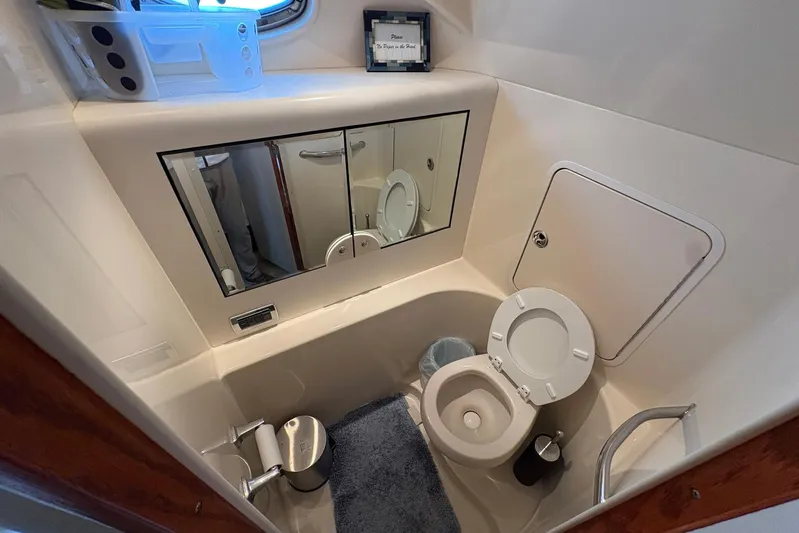Andiamo II Yacht Photos Pics Bathroom interior of 2002 Sea Ray 480 Motor Yacht, featuring toilet and mirror.