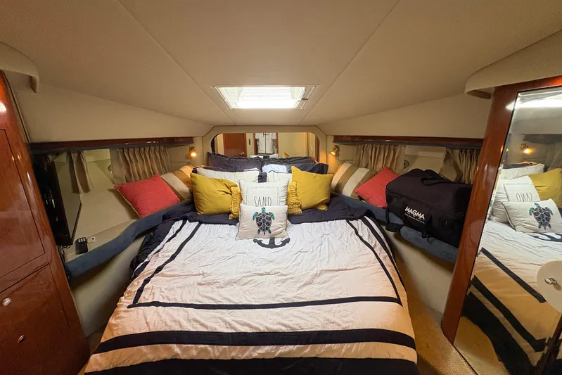 Andiamo II Yacht Photos Pics Luxurious bedroom interior of 2002 Sea Ray 480 Motor Yacht with plush bedding and pillows.